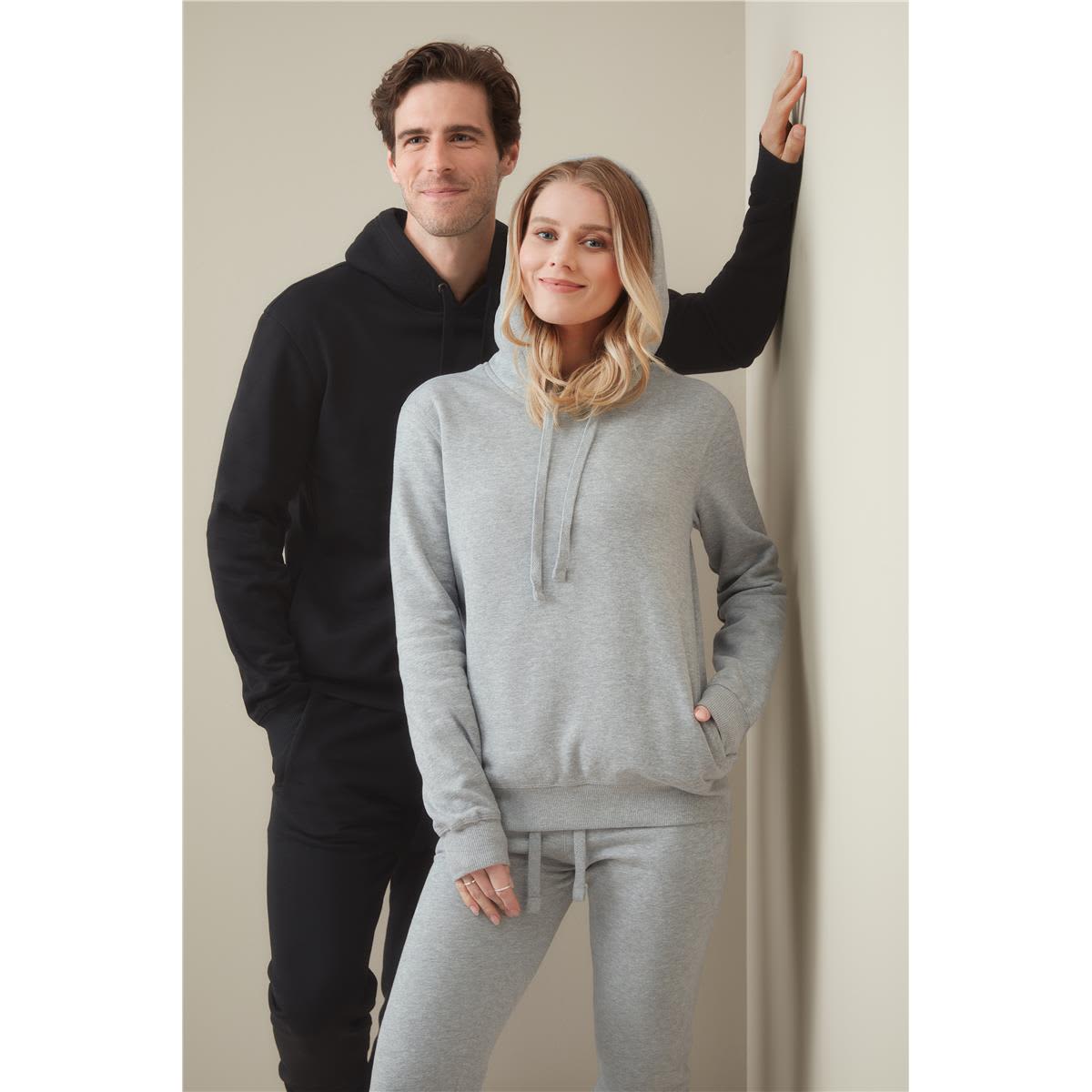 A black and grey unisex recycled sweatshirt hoodie displayed on models against a neutral background. Recycled Unisex Sweat Hoodie - Image 1