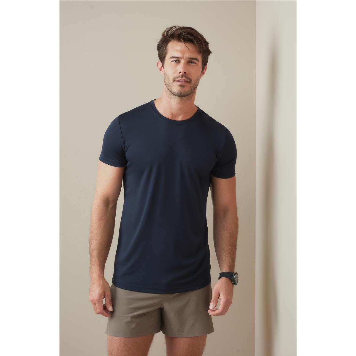 A navy blue men's active sports t-shirt displayed on a model wearing khaki shorts, featuring a simple logo. Men's Active Sports-T - Image 1