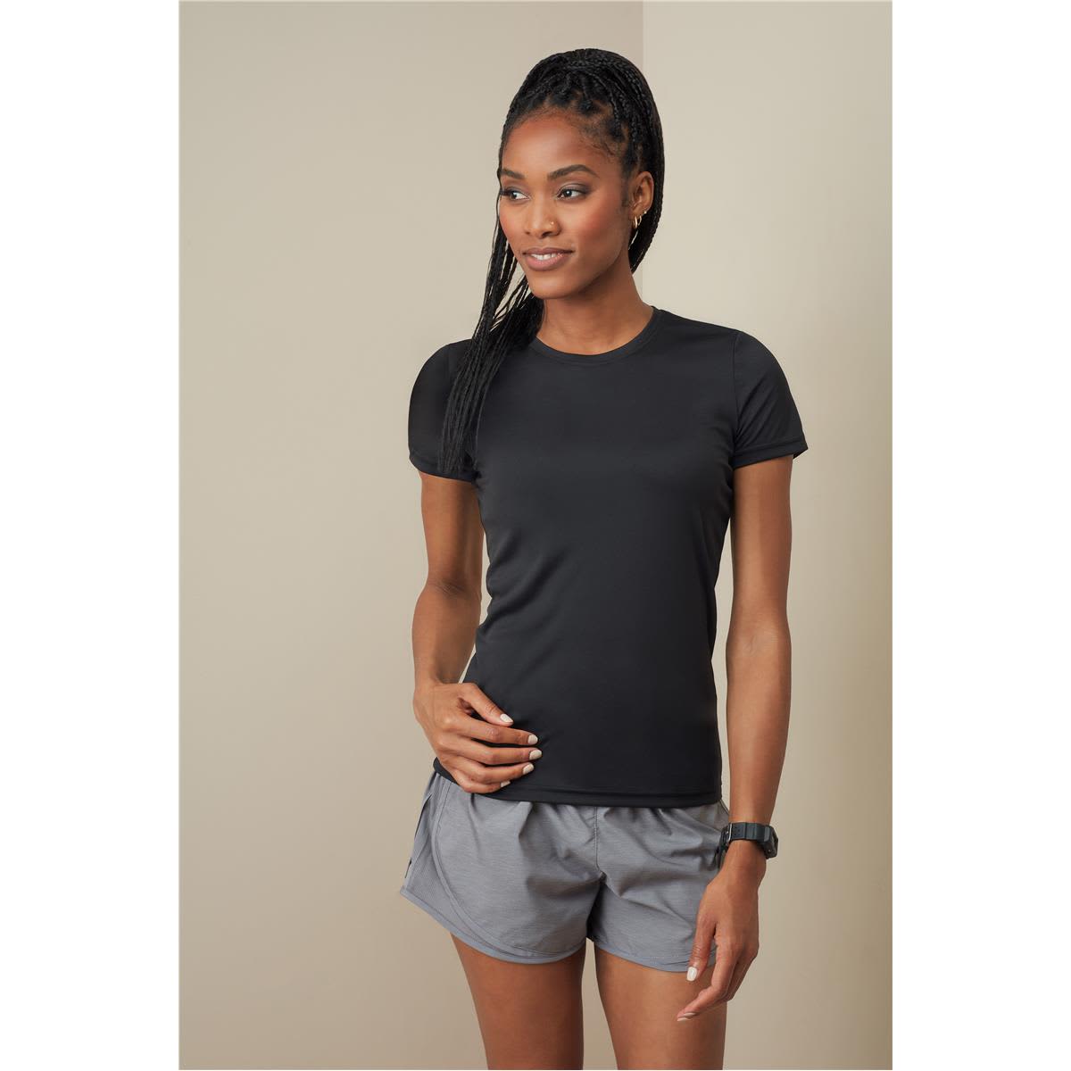 A black women's active sports T-shirt with short sleeves, paired with grey athletic shorts. The model is standing confidently. Women's Active Sports-T - Image 1