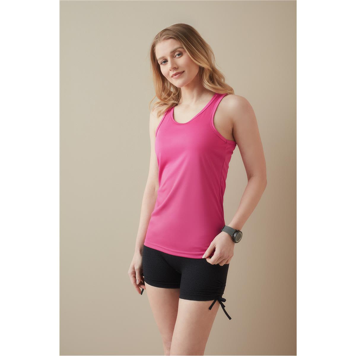 A model is wearing a pink women's active sports top paired with black shorts. The top features a logo. Women's Active Sports Top - Image 1