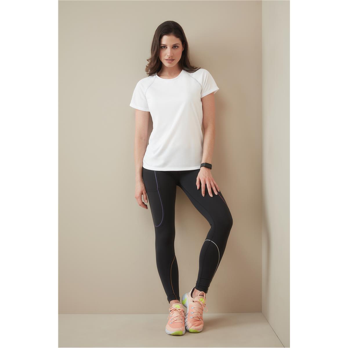 A white women's athletic t-shirt is worn with black leggings and sporty shoes, featuring a logo. Women's Active Team Raglan - Image 1