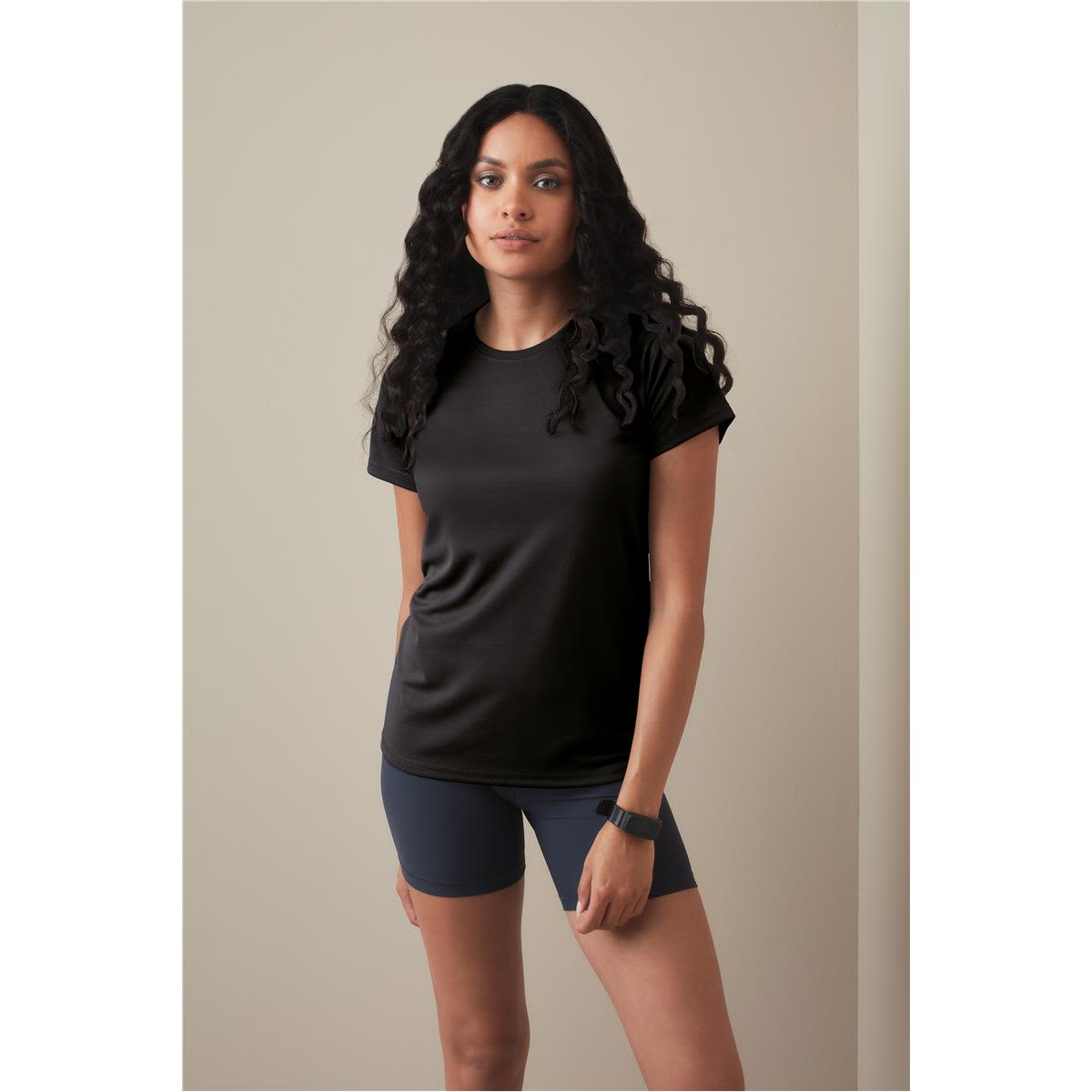 A black women's active t-shirt with raglan sleeves, paired with navy shorts, modelled against a neutral background. Women's Active 140 Raglan - Image 1