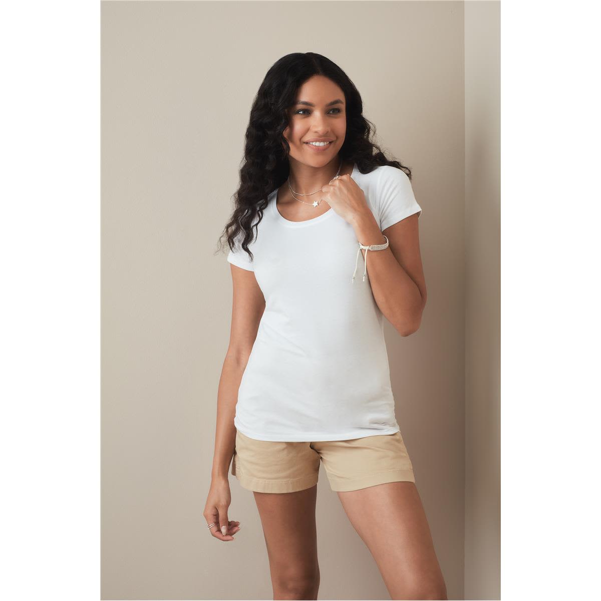 A woman models a white crew neck t-shirt paired with light brown shorts, standing against a neutral background. Women's Claire Crew Neck - Image 1