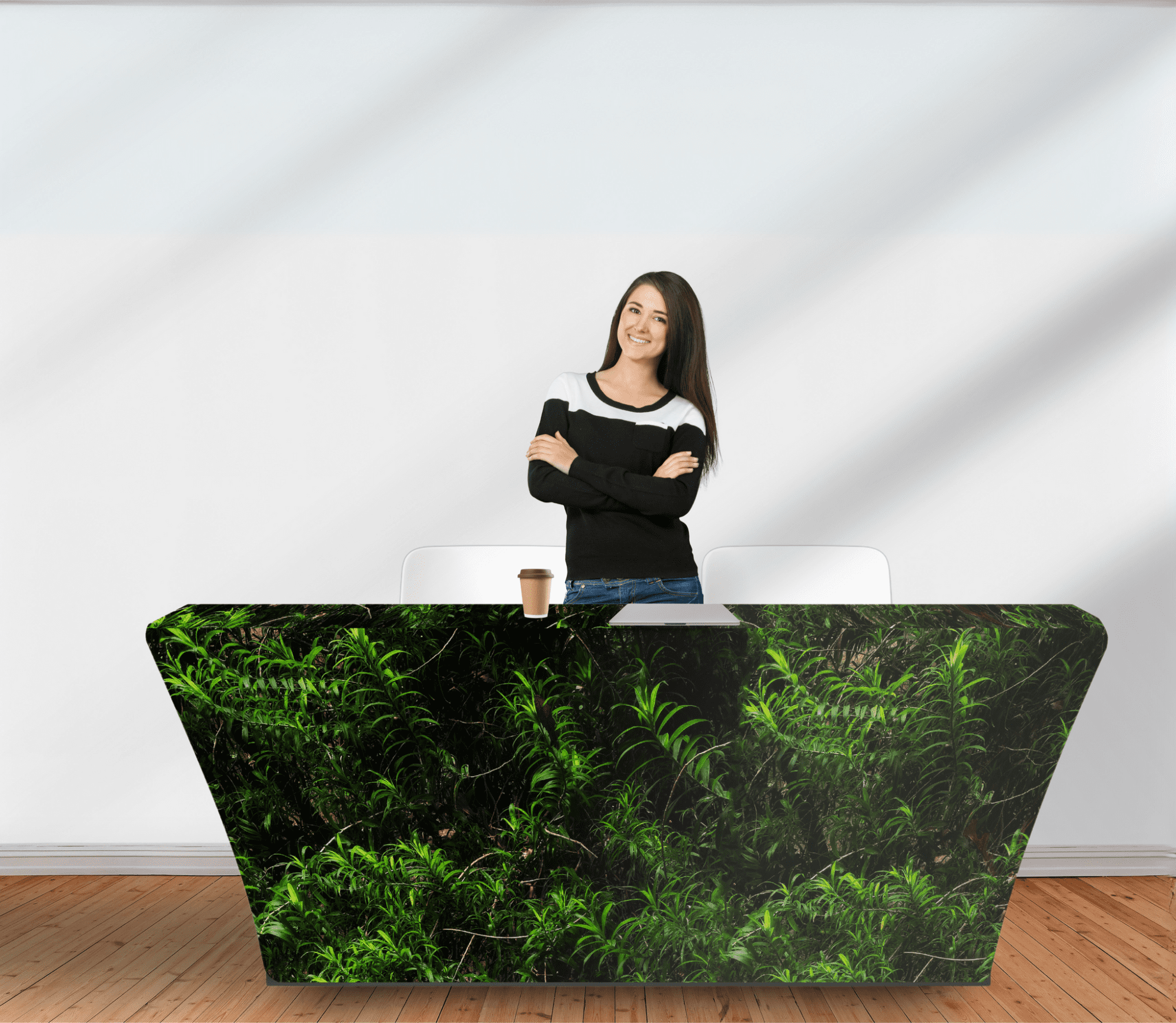 A rPET stretched table cover in green featuring a leafy design, placed on a table with a seated person and coffee cup. rPET Stretched Table Cover 6ft (1800mm) - Image 1