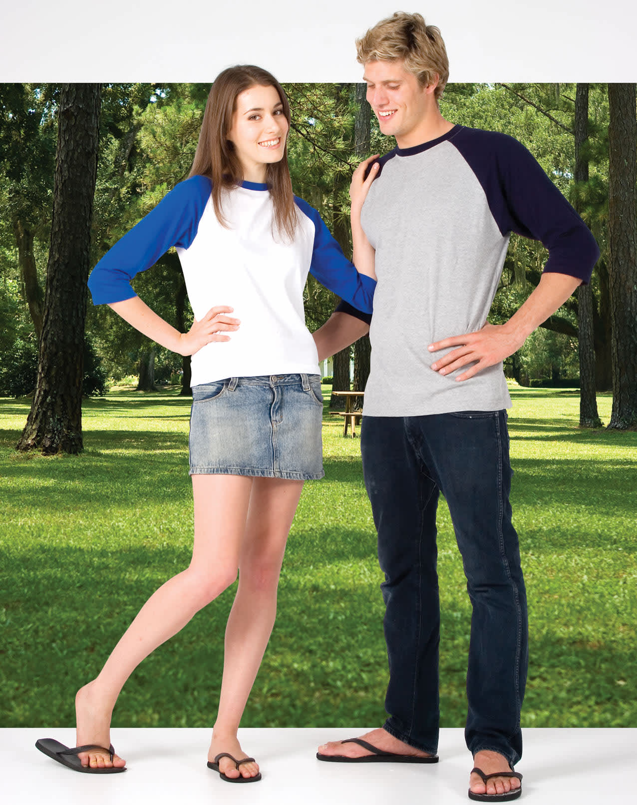 A woman in a white and blue 3/4 sleeve raglan T-shirt and a man in a grey T-shirt with navy sleeves stand outdoors. Women's 3/4 Sleeve Raglan T-shirt - Image 1