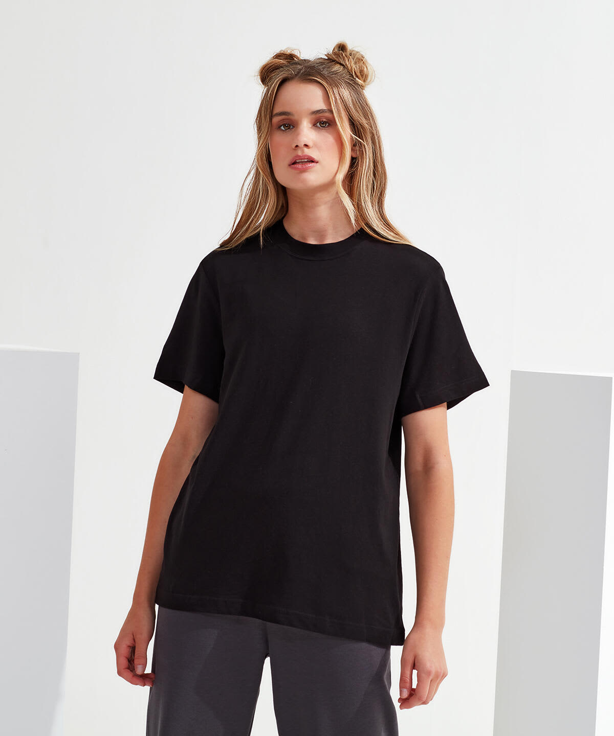A black oversized t-shirt with a boxy fit and short sleeves, featuring a branding logo. Organic Boxy Oversized T-Shirt - Image 1