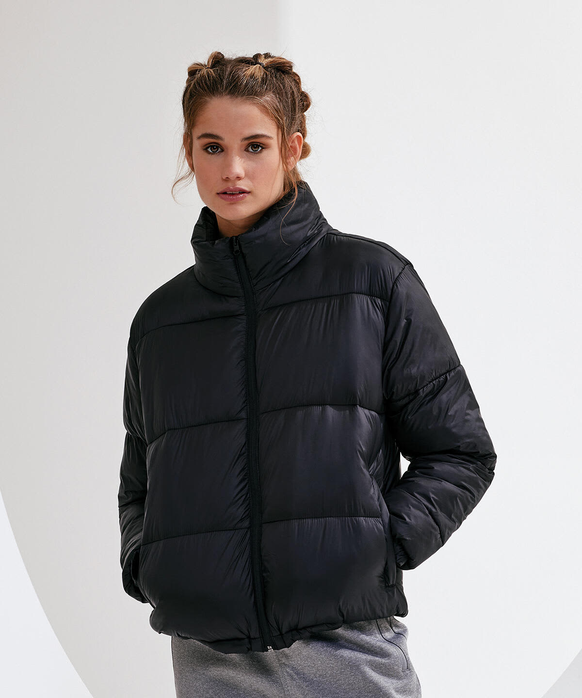 A black padded jacket is displayed on a model, featuring a high collar and a quilted design. Padded Jacket - Image 1