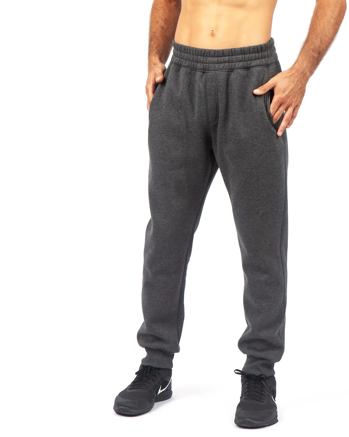 Grey brushed fleece track pants with an elastic waistband and side pockets, modelled by a person. Mens' STANCE brushed fleece pants - Image 1