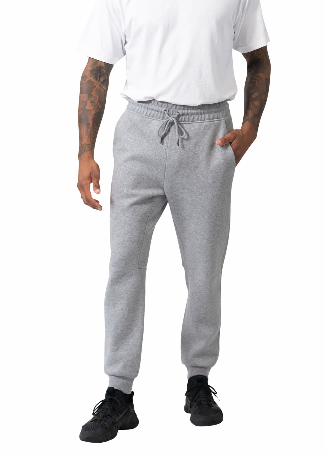 A person wearing grey men's three-layer cotton sandwich pants, featuring an elastic waistband and side pockets. Men's three layer Cotton Sandwich Pants - Image 1