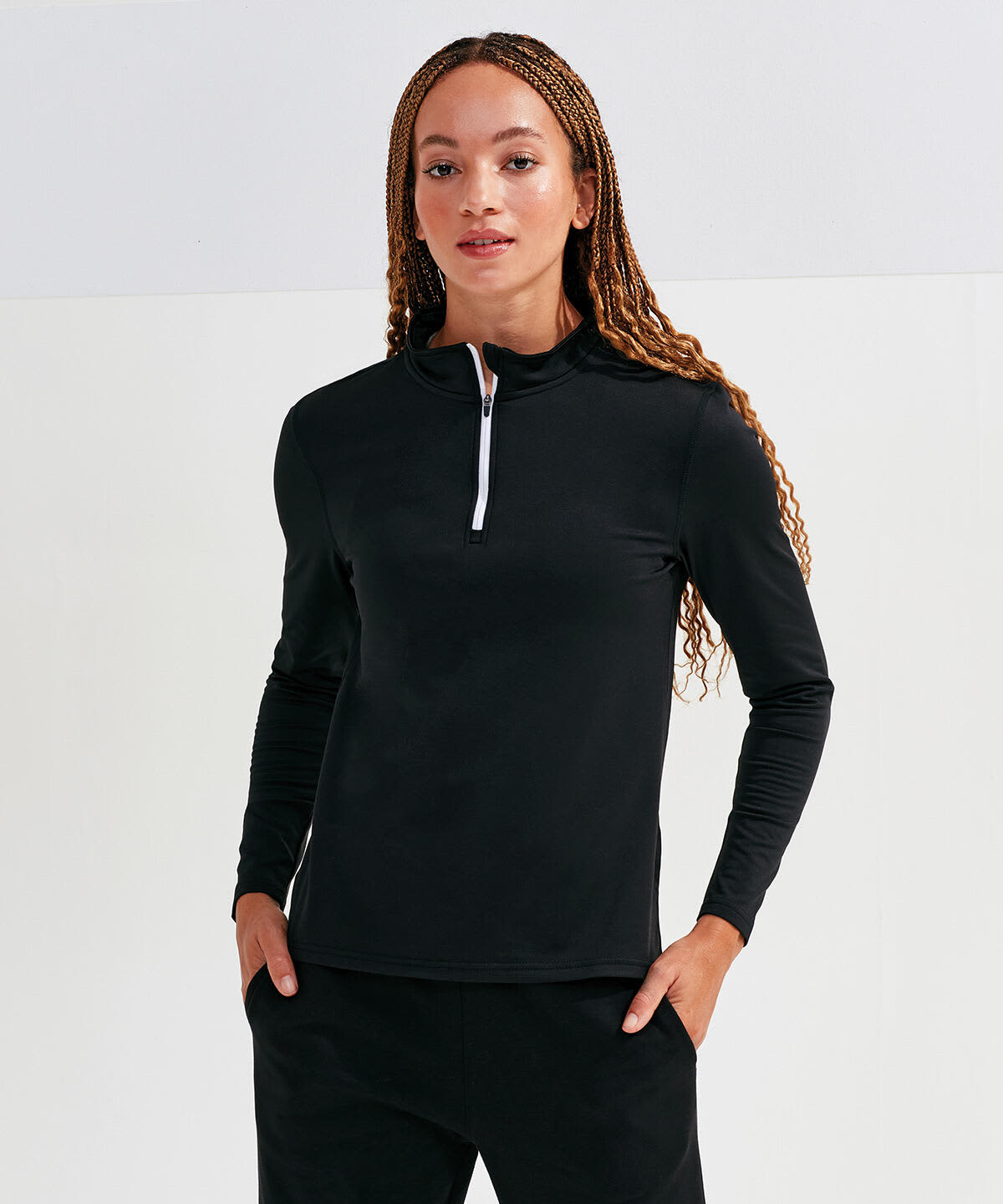 A black long sleeve brushed back 1/4 zip top, featuring a contrasting white zip and a fitted design. Recycled Long Sleeve Brushed Back 1/4 Zip Top - Image 1