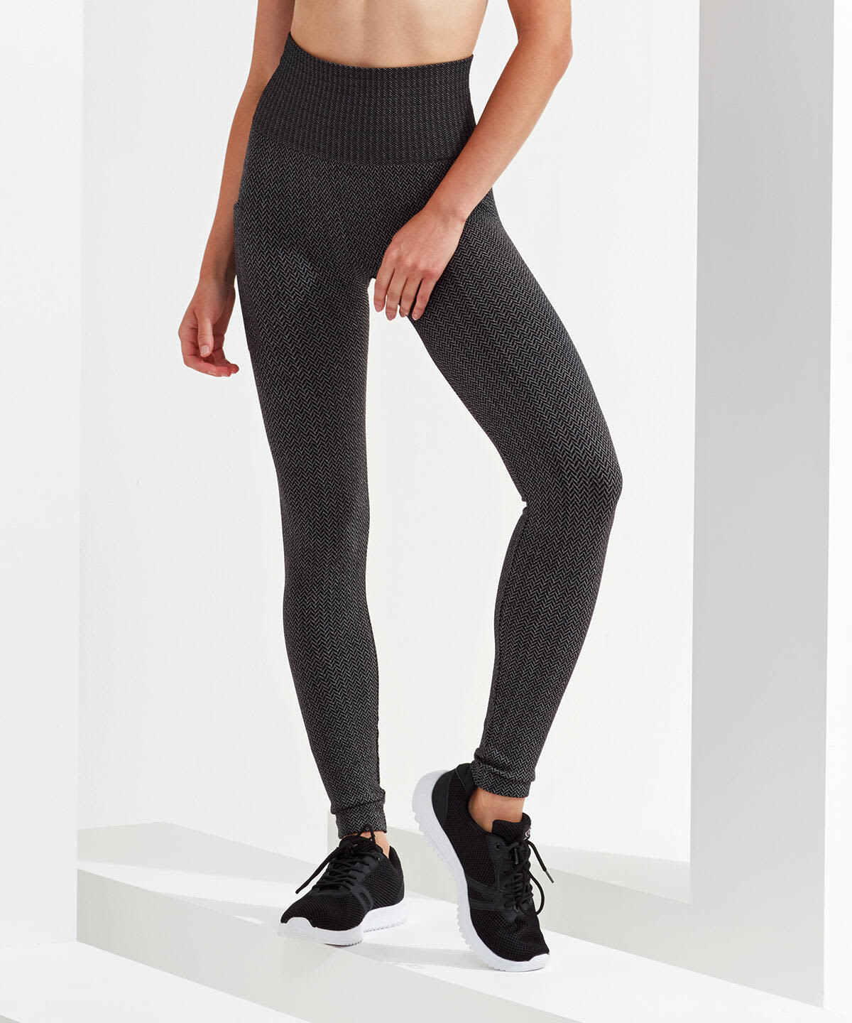 Knitted city leggings in a dark grey colour, featuring a high waistband and a fitted style, paired with black sneakers. Knitted City Leggings - Image 1
