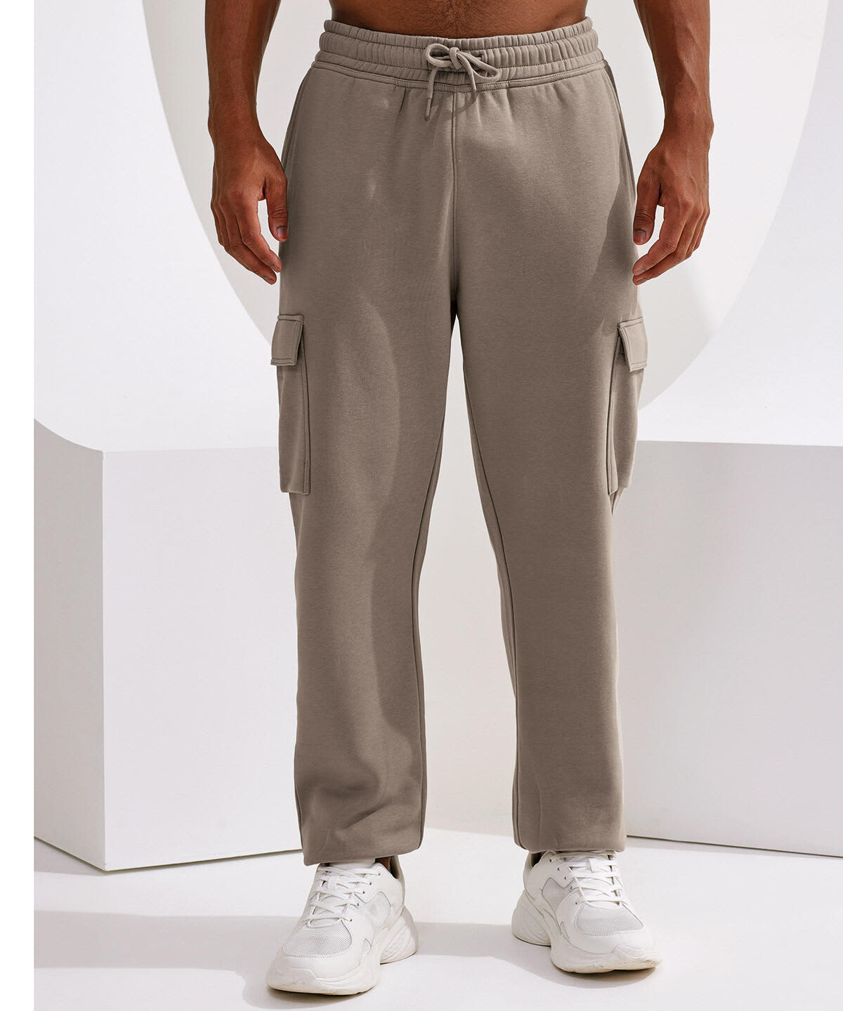 Unisex cargo joggers in a light beige colour with side pockets and a drawstring waist, featuring a logo. Unisex Cargo Recycled Joggers - Image 1