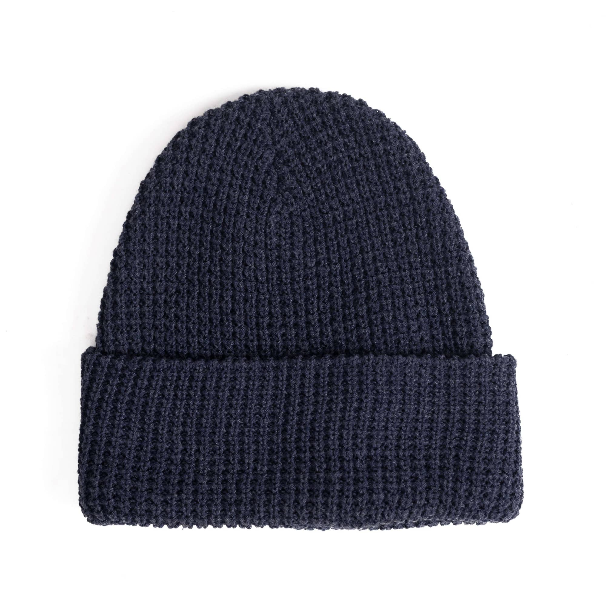 A navy waffle knit beanie with a rolled cuff and a logo. Waffle Knit Beanie - Image 1