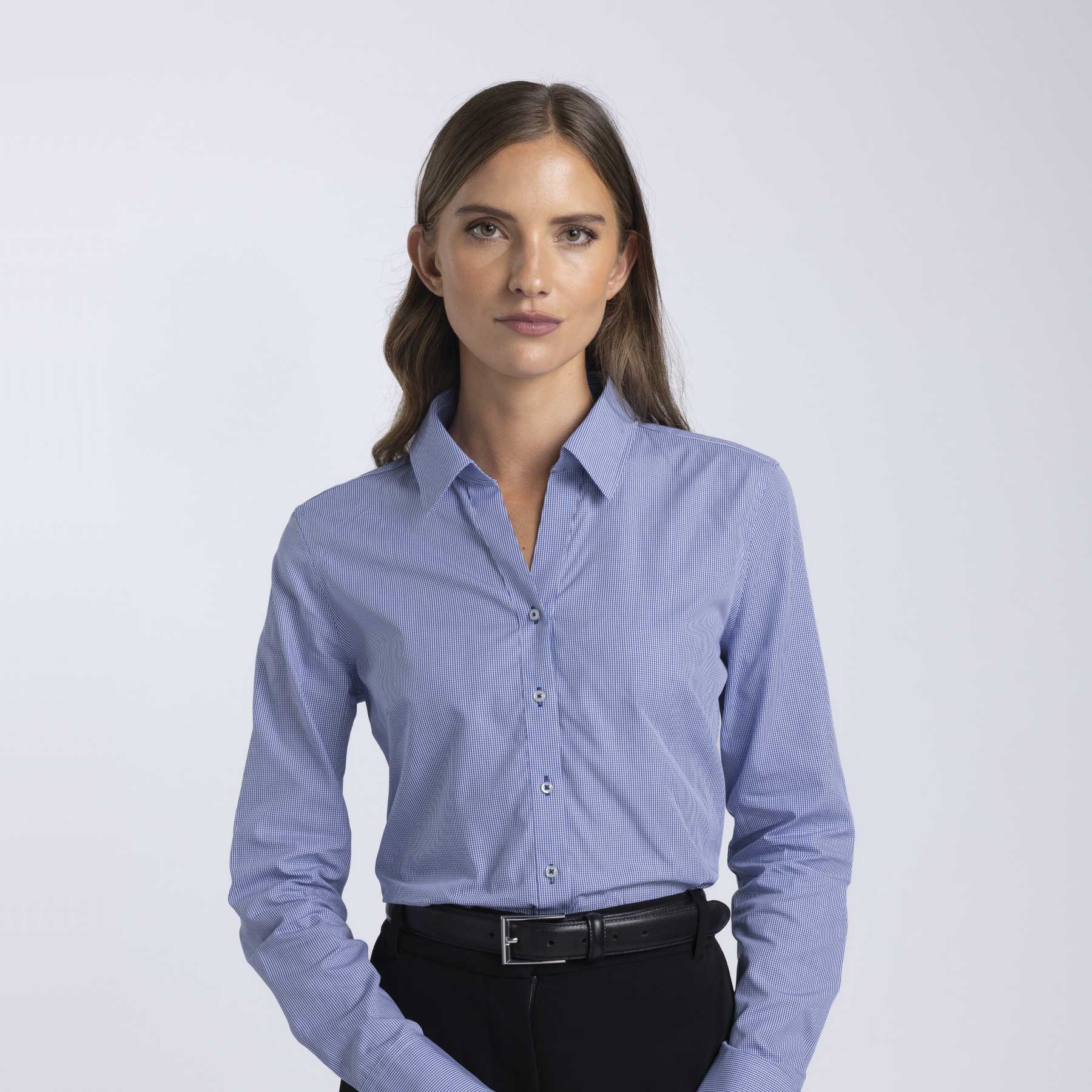 A button-up women's shirt in light blue with a collar and long sleeves, featuring a logo. Barkers Corporate Fremont Check Shirt – Womens - Image 1