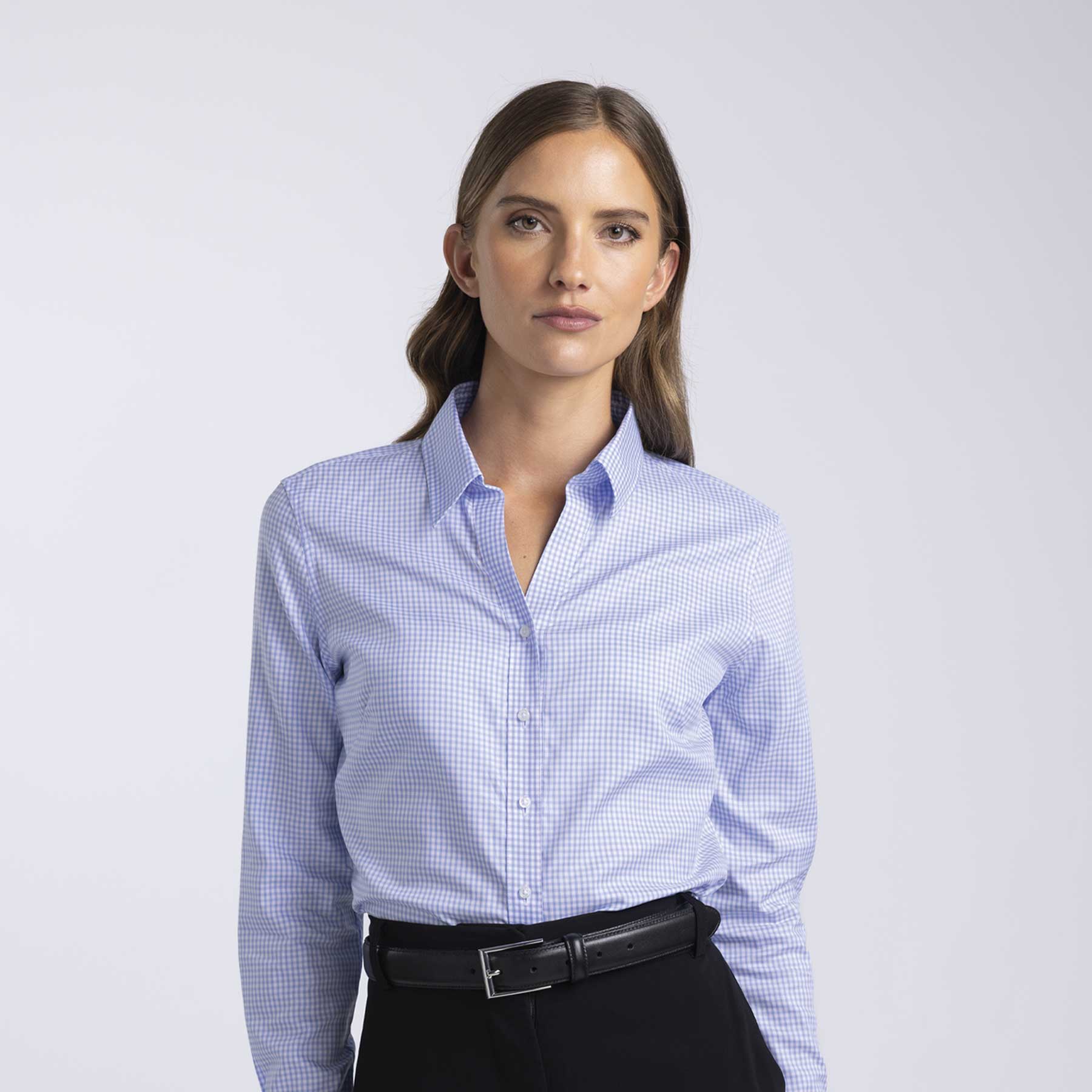 A women's button-up shirt featuring a blue and white check pattern, with a collar and button front. It has a logo. Barkers Corporate Hudson Check Shirt – Womens - Image 1