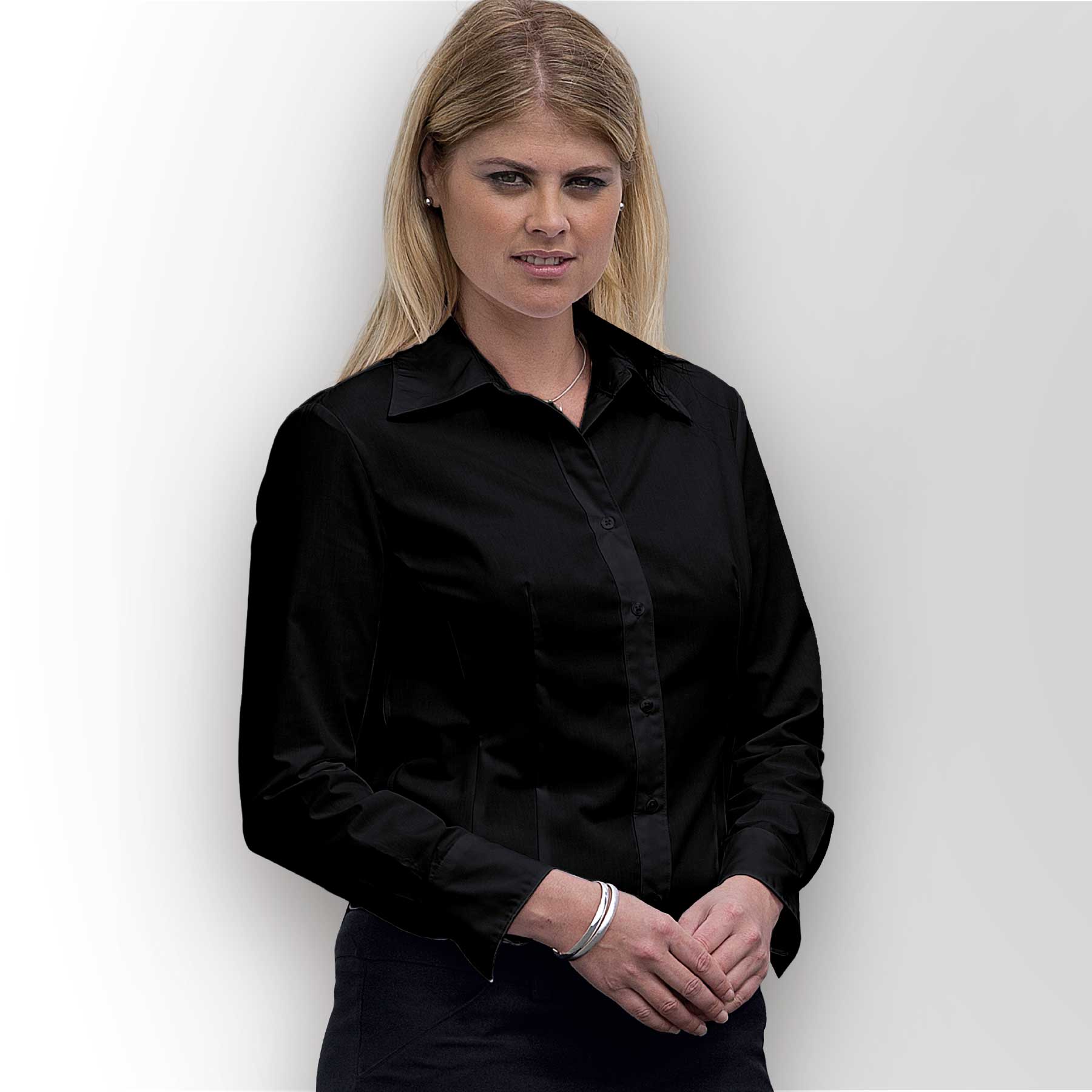 A black women's button-up shirt with long sleeves and a sleek fit, featuring a collar and one logo. The Traveller Shirt - Womens - Image 1