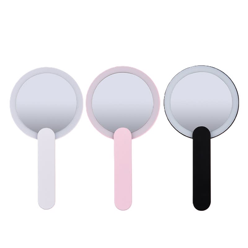 A set of three handheld mirrors in white, pink, and black, each with a round reflective surface and a handle. Travel Light Up Mirror - Image 1