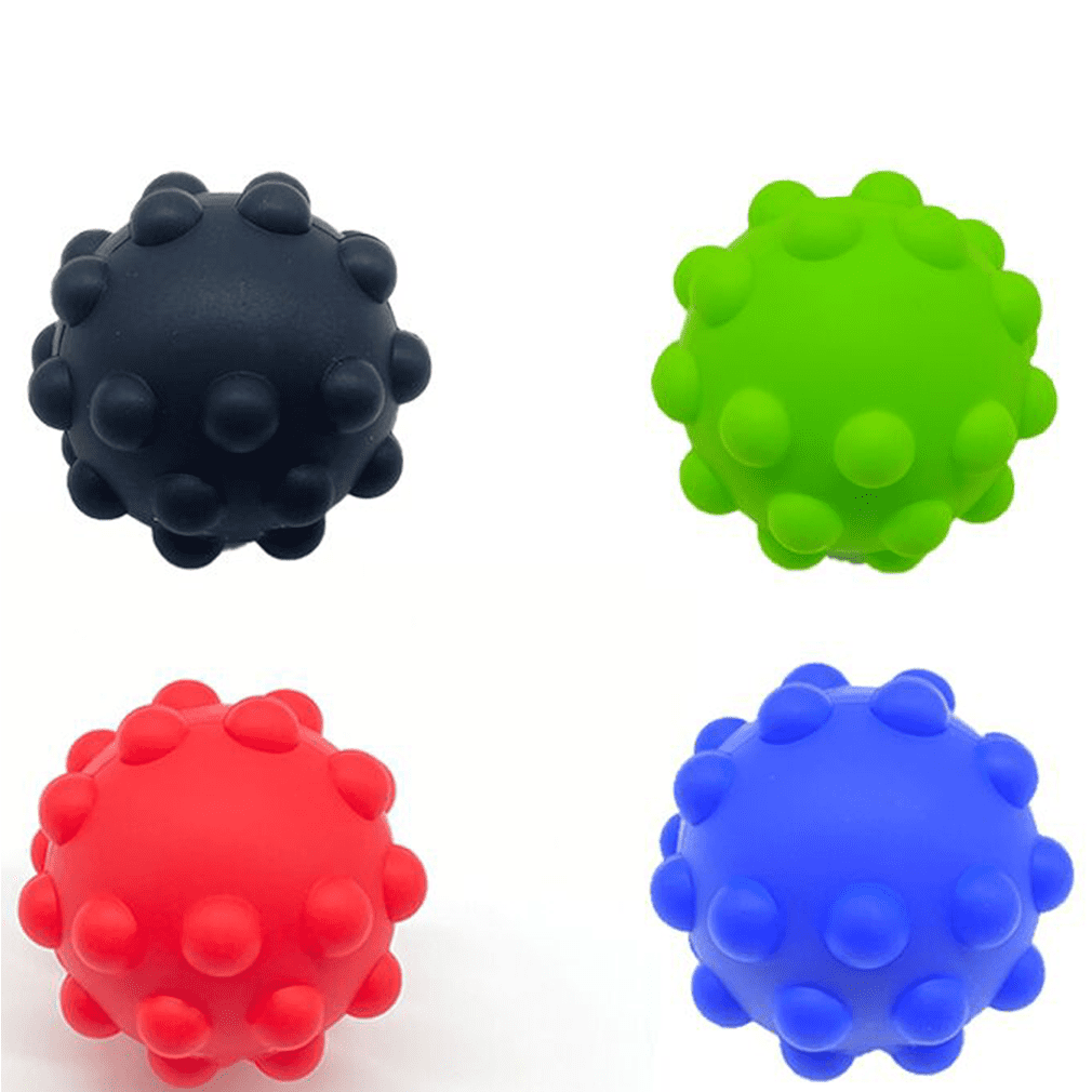 A collection of four bouncy balls in black, green, red, and blue, featuring a textured surface with bumps. Push Pop Bouncing Ball - Image 1