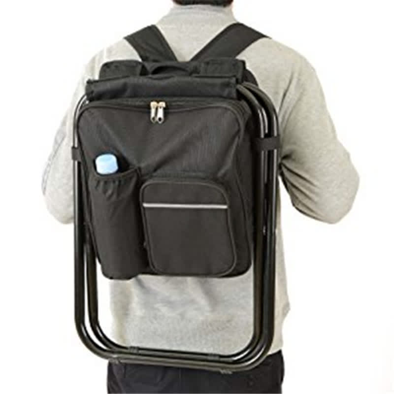 A black backpack-style chair with a drink pocket, worn on the back of a person. Features a simple design with zippers. Basecamp Camp Throne - Image 1