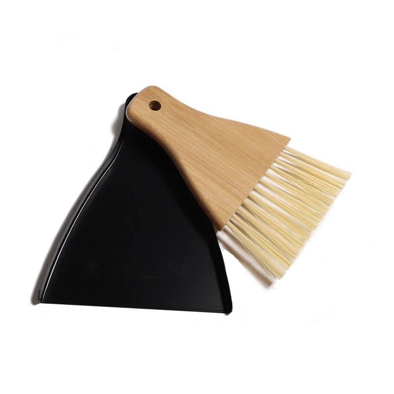 A bamboo brush and black dustpan set, featuring a natural wood handle and bristles. Bamboo Brush & Dustpan - Image 1