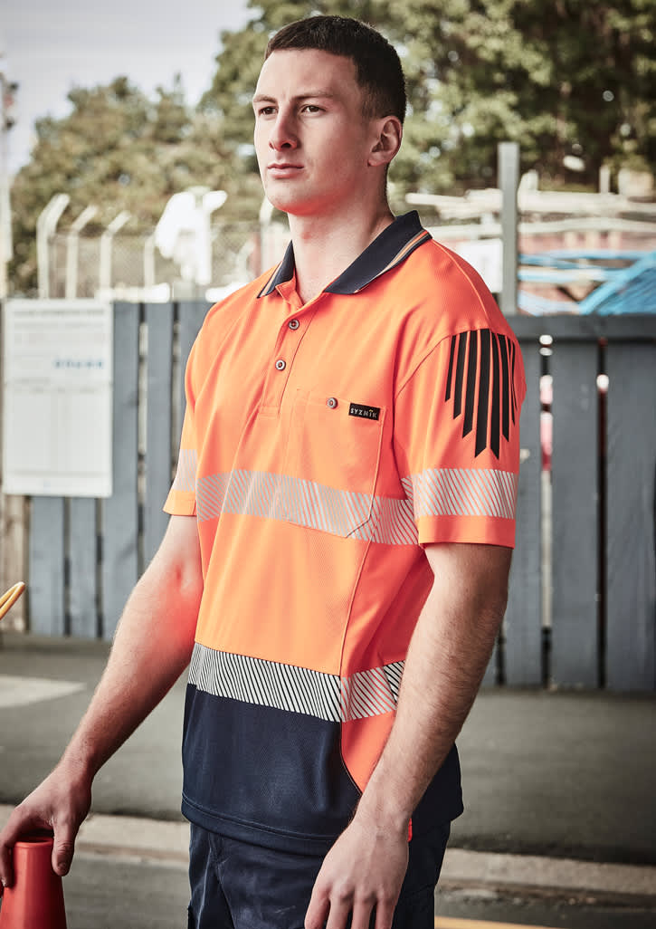 A high-visibility short sleeve polo in bright orange and navy, featuring segmented reflective tape and a logo. Mens Hi Vis Flux Segmented Tape Short Sleeve Polo - Image 1