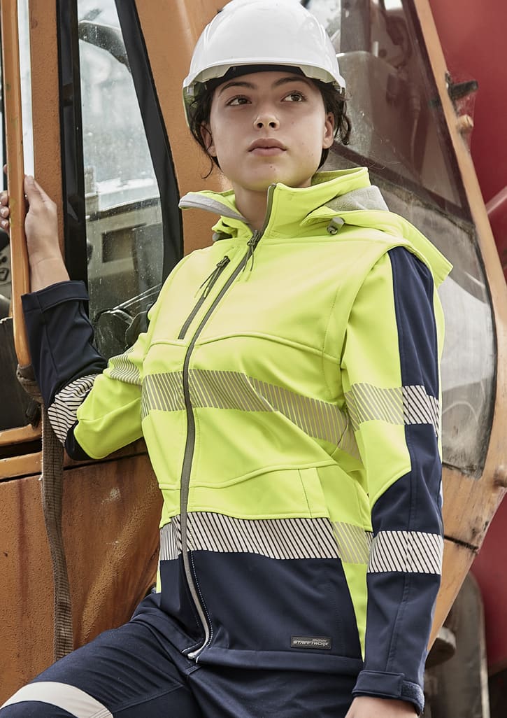 A women's softshell jacket in hi-vis yellow and navy blue, featuring reflective stripes and a hood. It has a logo on the front. Womens Streetworx 2 In 1 Stretch Softshell Jacket - Image 1