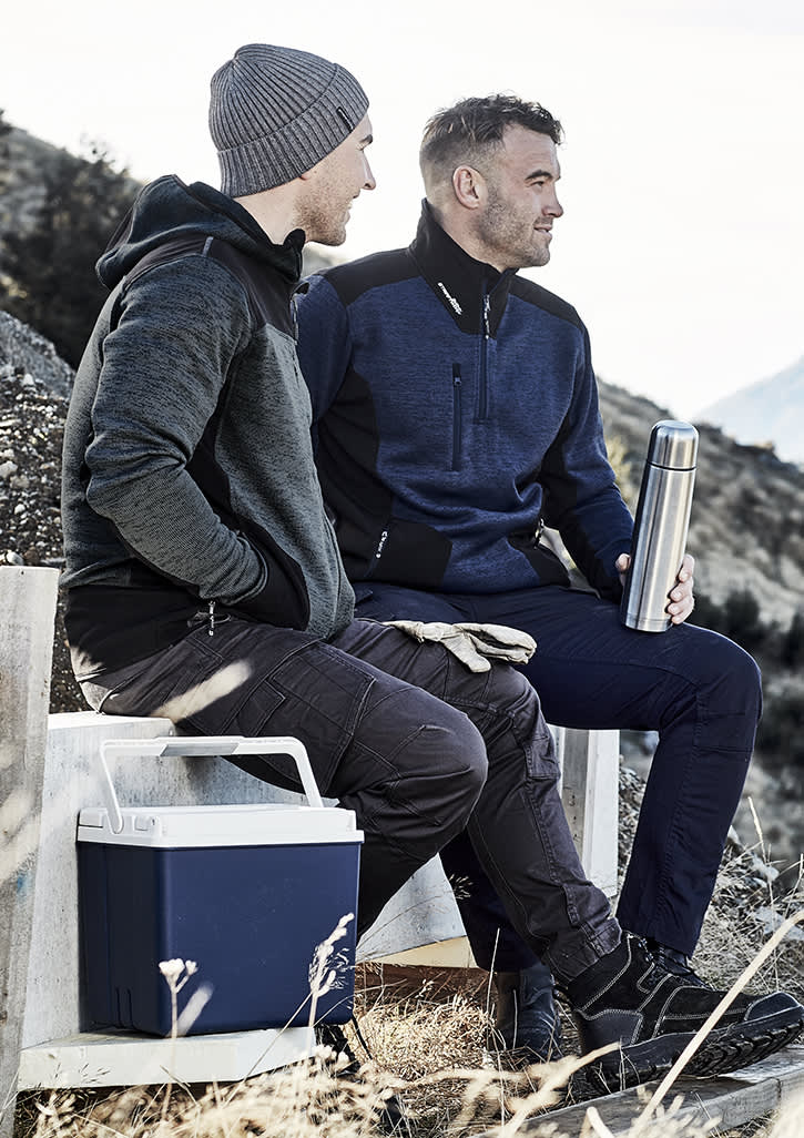 Two men seated outdoors, one wearing a grey reinforced knit hoodie and the other in a navy pullover, holding a drink bottle. Unisex Streetworx Reinforced Knit 1/2 Zip Pullover - Image 1