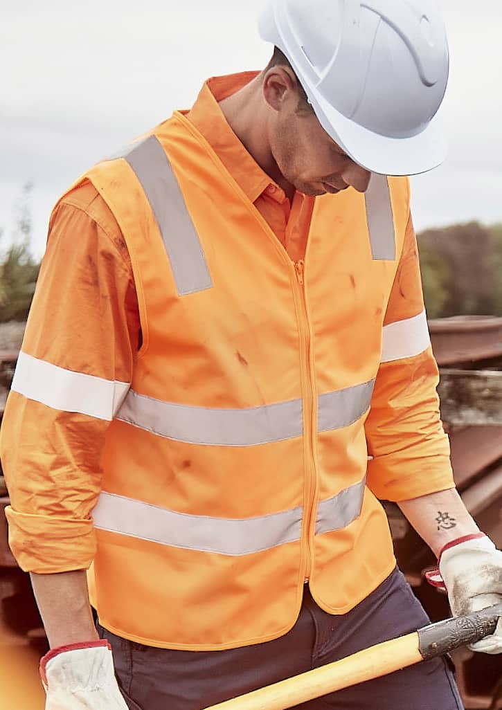 An orange unisex hi-vis vest with silver reflective strips, worn over a long-sleeve shirt, featuring a safety helmet. Unisex Hi Vis VIC Rail Zip Vest - Image 1