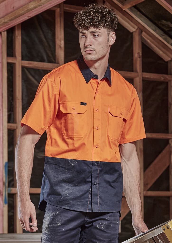A short sleeve work shirt in bright orange and navy blue, featuring two chest pockets and a logo. Mens Hi Vis Short Sleeve Shirt - Image 1