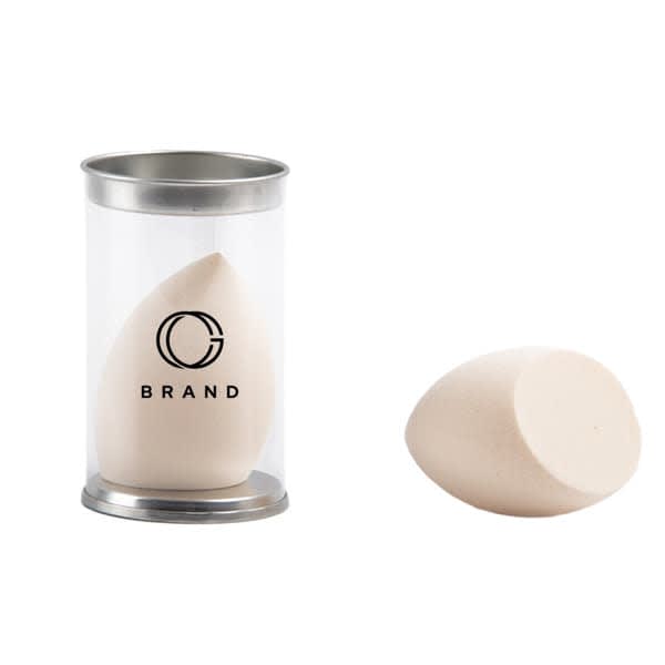 A beauty makeup sponge in a transparent container, featuring a rounded shape and a light beige colour. Promotional Beauty Makeup Sponge - Image 1