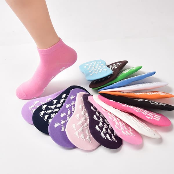 Non-slip yoga socks in various colours including purple, pink, blue, green, and black, with grip patterns on the soles. Non Slip Yoga Socks With Grip - Image 1