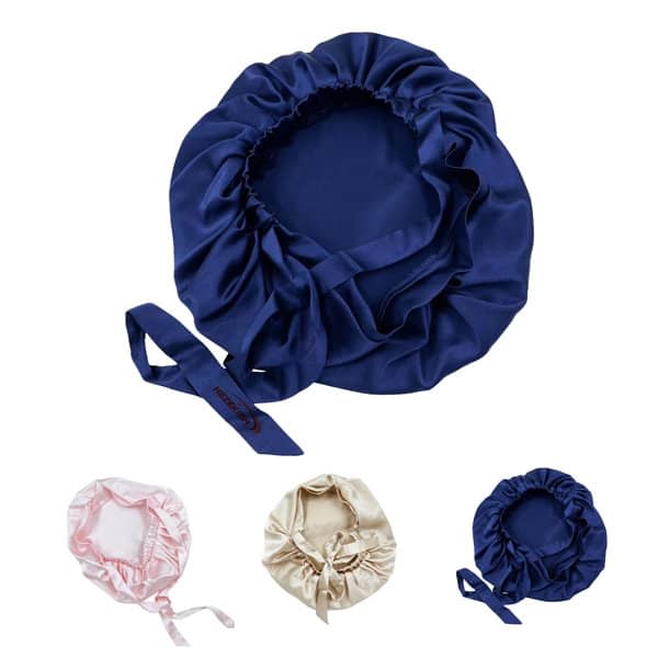 A set of silk nightcaps in navy blue, pink, and cream, featuring soft, gathered fabric and ribbon ties. 19 Momme Silk Nightcap - Image 1