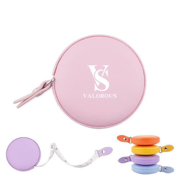 A pink mini PU leather round measuring tape, featuring a retractable tape with a variety of colourful options. 150cm Mini PU Leather Round Measuring Tape - Image 1