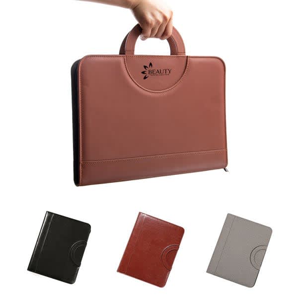 A brown zippered padfolio with a handle, features black, brown, and grey variants below. Contains a logo. A4 PU Leather Zippered Padfolio With Handle - Image 1