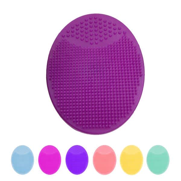 An oval silicone face scrubber in purple, featuring a textured surface, with six additional colour options below. Oval Silicone Face Scrubber - Image 1