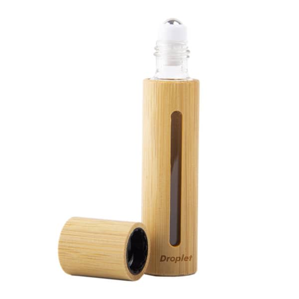 A 10ml bamboo glass roll-on bottle with a transparent window, featuring a natural bamboo exterior and a round rollerball top. 10ml Bamboo Glass Roll On Bottle With Window - Image 1