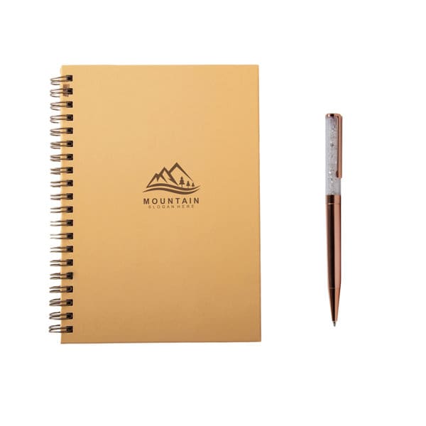 A gold hardcover spiral notebook with a logo and a glitter ballpoint pen in rose gold. Hardcover Spiral Noteook With Glitter Ballpoint Pen - Image 1