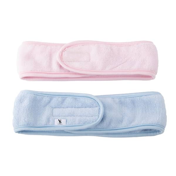 Two soft headbands in pink and light blue, featuring adjustable closures and a branding tag. Magic Tape Spa Headband - Image 1