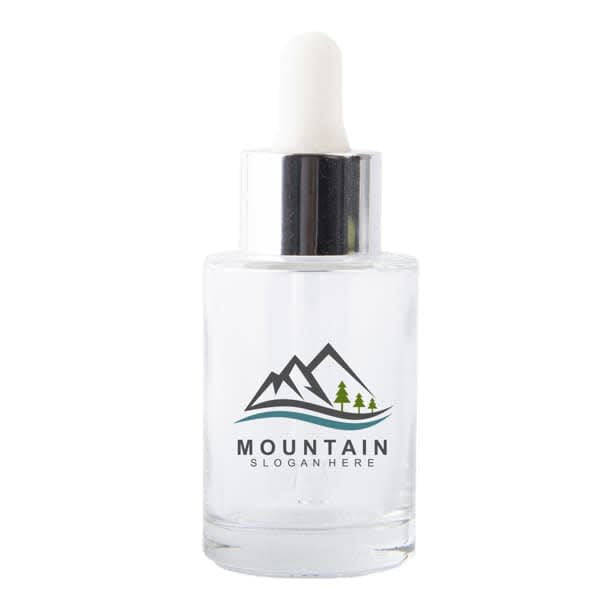 A clear glass dropper bottle with a white dropper top and a simple logo featuring mountains and trees. 1oz. Glass Dropper Bottle - Image 1