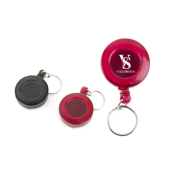 A red and black round ABS retractable badge holder with key rings, featuring a logo on the red holder. Round ABS Retractable Badge Holder With Key Ring - Image 1