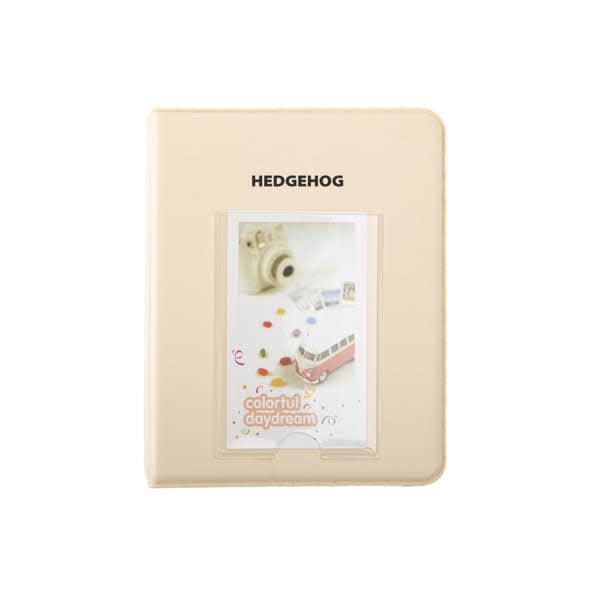 A cream-coloured mini photo album with a simple design and a photo slot on the front, featuring a logo. 64 Pockets Mini Instant Polaroid Photo Album - Image 1