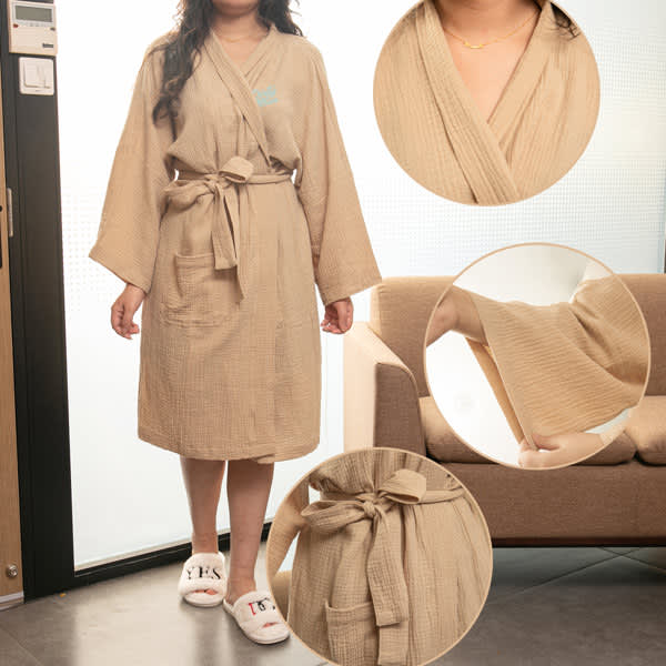 A long cotton bathrobe in a soft beige colour, featuring a belt and pockets, displayed on a model. Women Long Cotton Bathrobe - Image 1