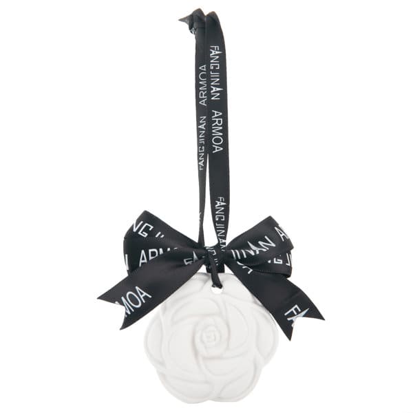 A white hanging gypsum aromatherapy tablet in the shape of a flower, secured with a black ribbon and bow. Hanging Gypsum Aromatherapy Tablet - Image 1
