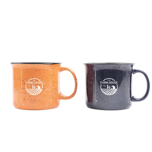 A ceramic campfire mug set featuring an orange and a dark blue mug, each with a logo. 15 oz. Custom Printed Ceramic Campfire Mug - Image 1
