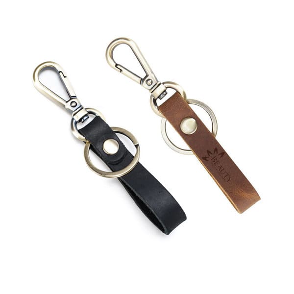 A custom vintage cowhide keychain in black and brown featuring a metal clip and ring. It includes a logo on the leather. Custom Vintage Cowhide Keychain - Image 1