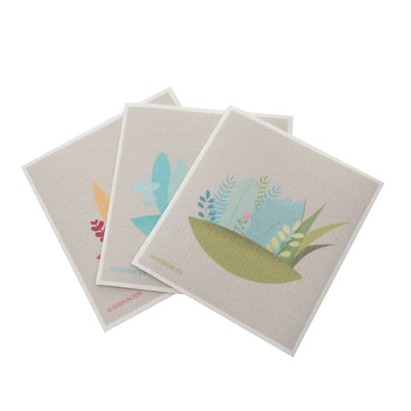Three customised eco-friendly degradable dish cloths featuring floral designs in pastel colours on a light background. Customized Eco Friendly Degradable Dish Cloth - Image 1
