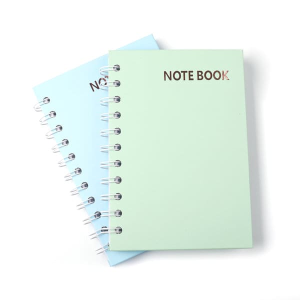 A6 hardcover spiral notebook in light blue and mint green, featuring a simple cover design and a logo. A6 Hardcover Spiral Notebook - Image 1
