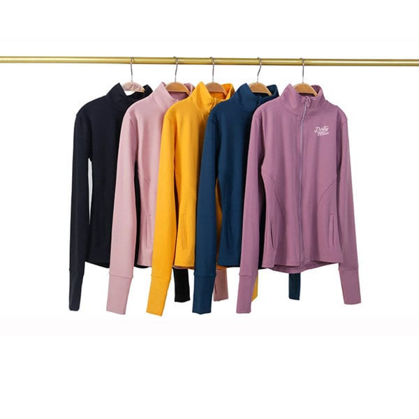 A collection of full zip yoga jackets in navy, pink, yellow, teal, and purple, hanging on a rack. Full Zip Yoga Jacket - Image 1