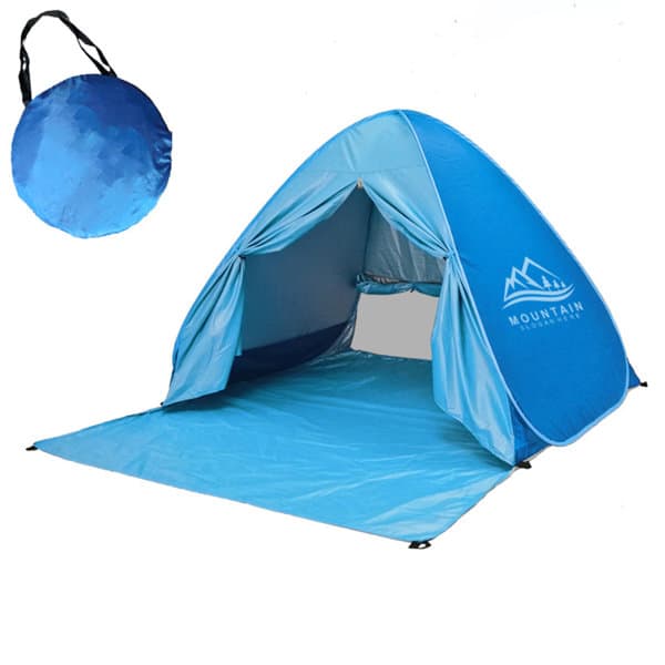 A blue pop-up beach tent with an inside view and a carry bag in the background. Features a logo on the tent. Pop Up Beach Tent - Image 1