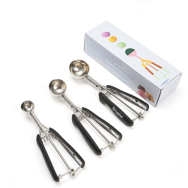 Three stainless steel ice cream scoops with black handles, displayed alongside their packaging. 3 Pcs Multifunctional Stainless Steel Ice Cream Scoop - Image 1